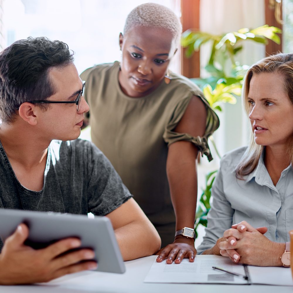 Shot of a group of businesspeople working together on a digital tablet in an office.